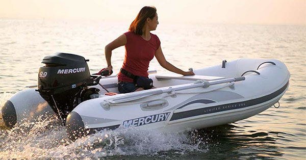 A woman enjoying boating in an inflatable boat.