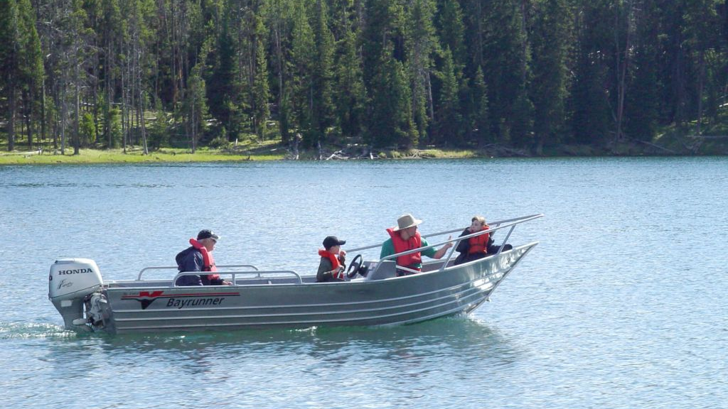 A group of people in a boat on a lake.