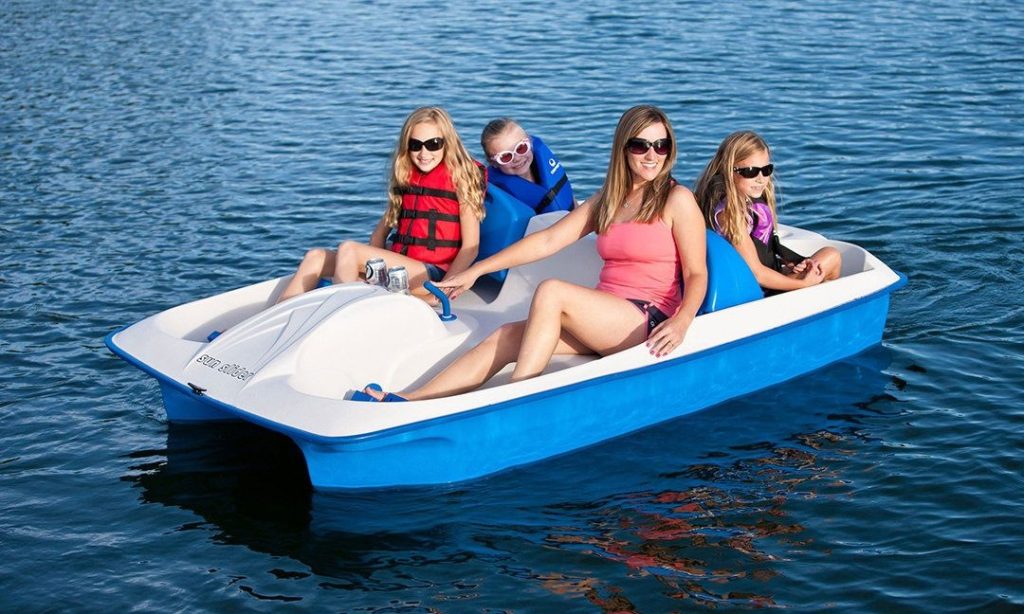 Beginners enjoying a popular activity as they ride on a boat in a lake.