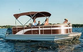Enthusiasts riding aboard a pontoon boat.