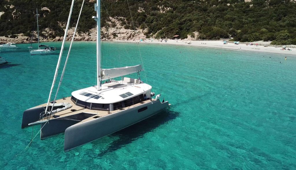 A catamaran is floating in the clear blue water, perfect for enthusiasts.